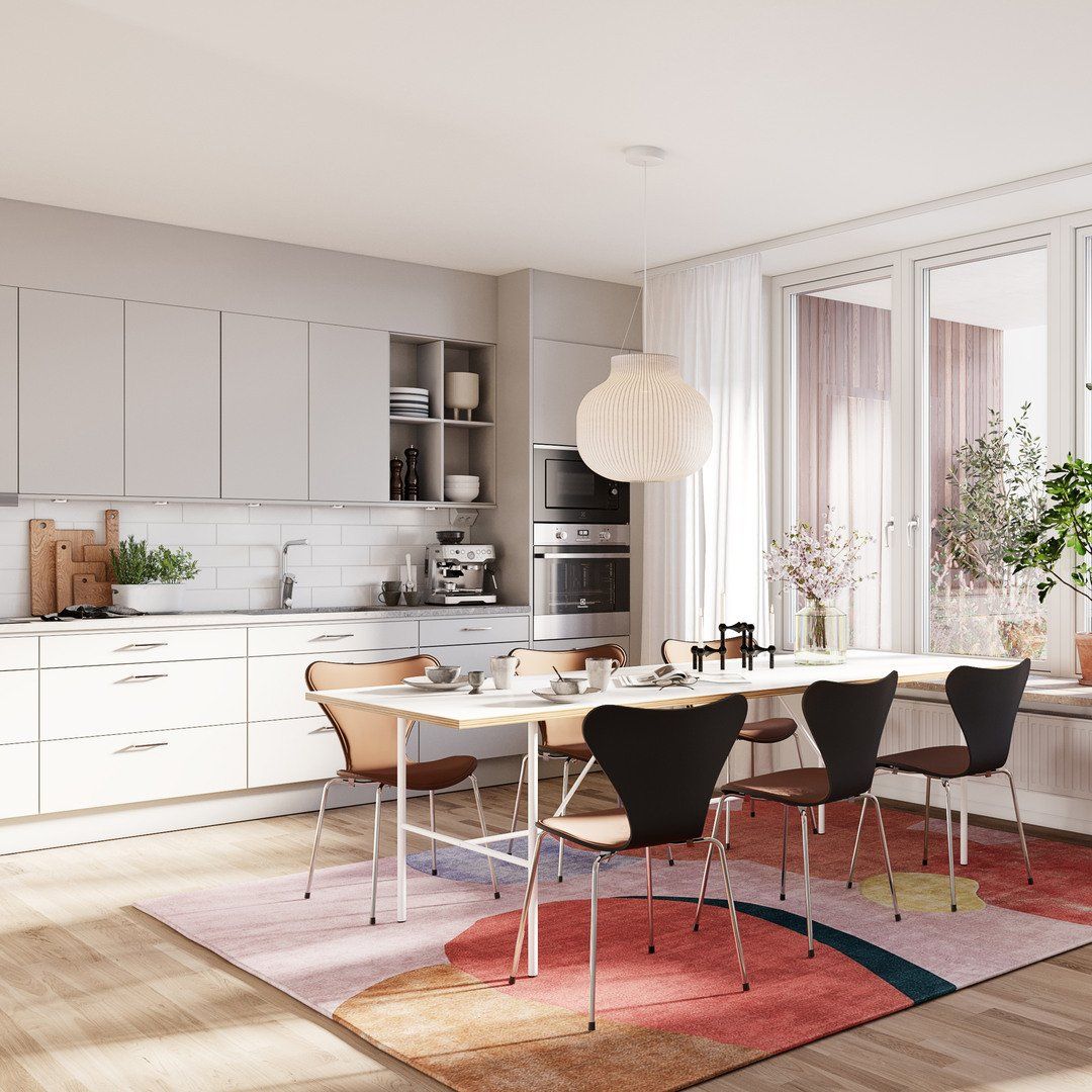 Vy över kök och vardagsrum med fin inredning