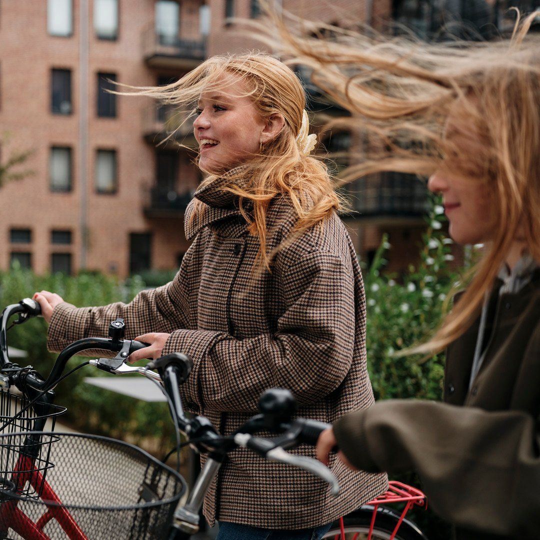 Två unga tjejkompisar med cyklar