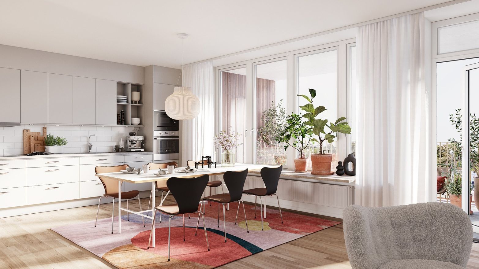 Vy över kök och vardagsrum med fin inredning
