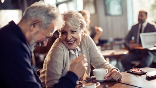 Äldre par som fikar